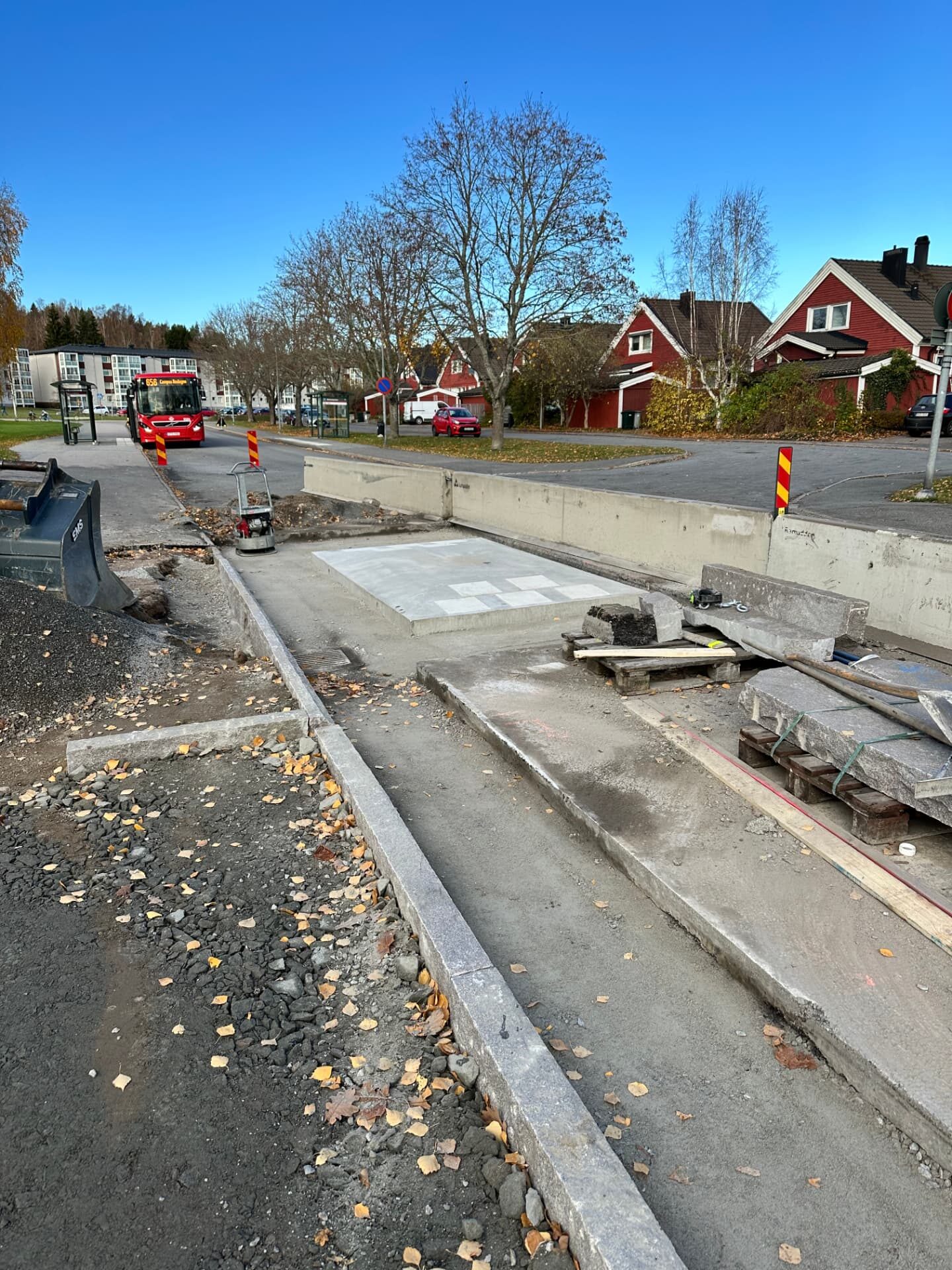 New concrete bus stop platform, granite kerbs and reinstated surfacing on a Swedish municipal street
