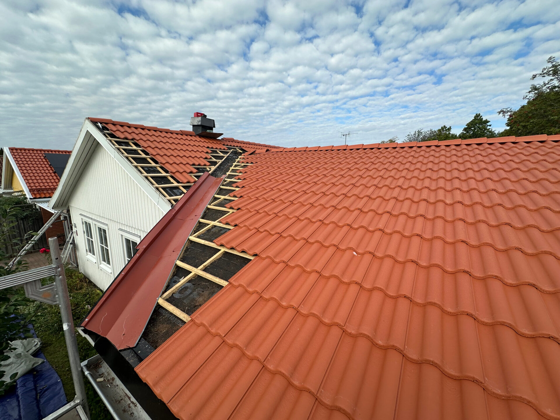 Roof mid-replacement with underlay, new battens and half the tiles laid