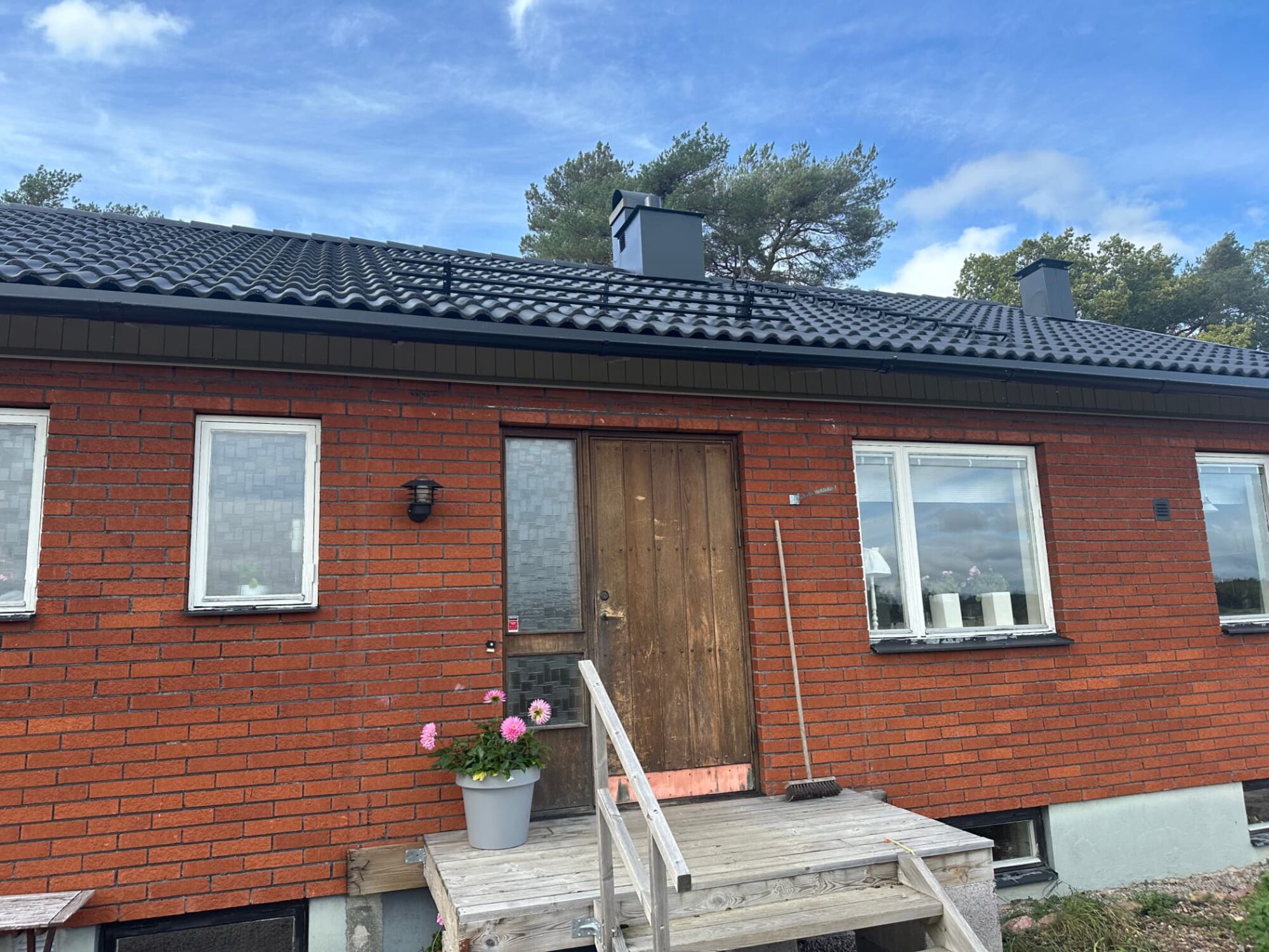 Front elevation showing the completed tile roof and ridge line