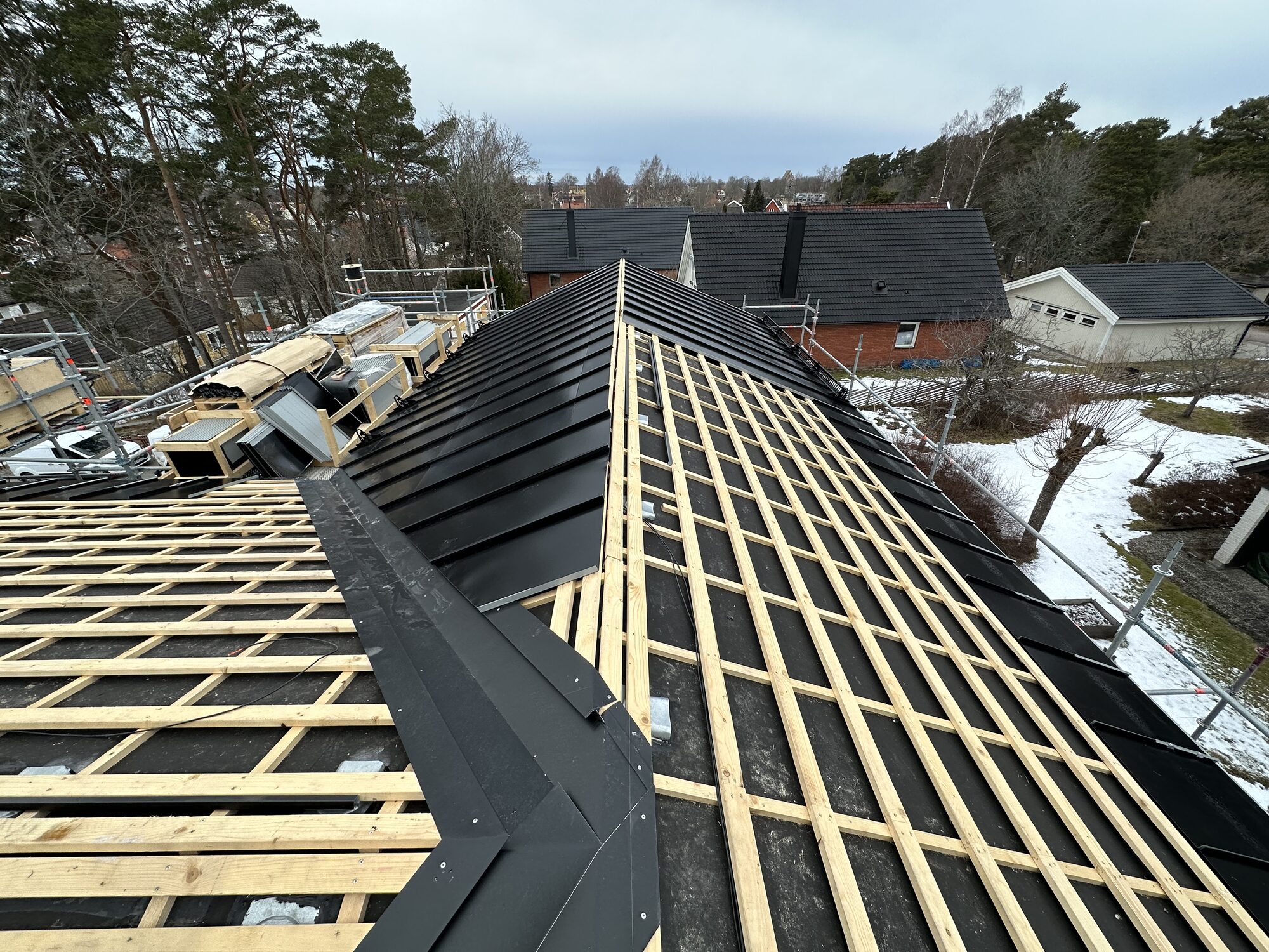 Battens and ridge detail with metal flashings in place before panels