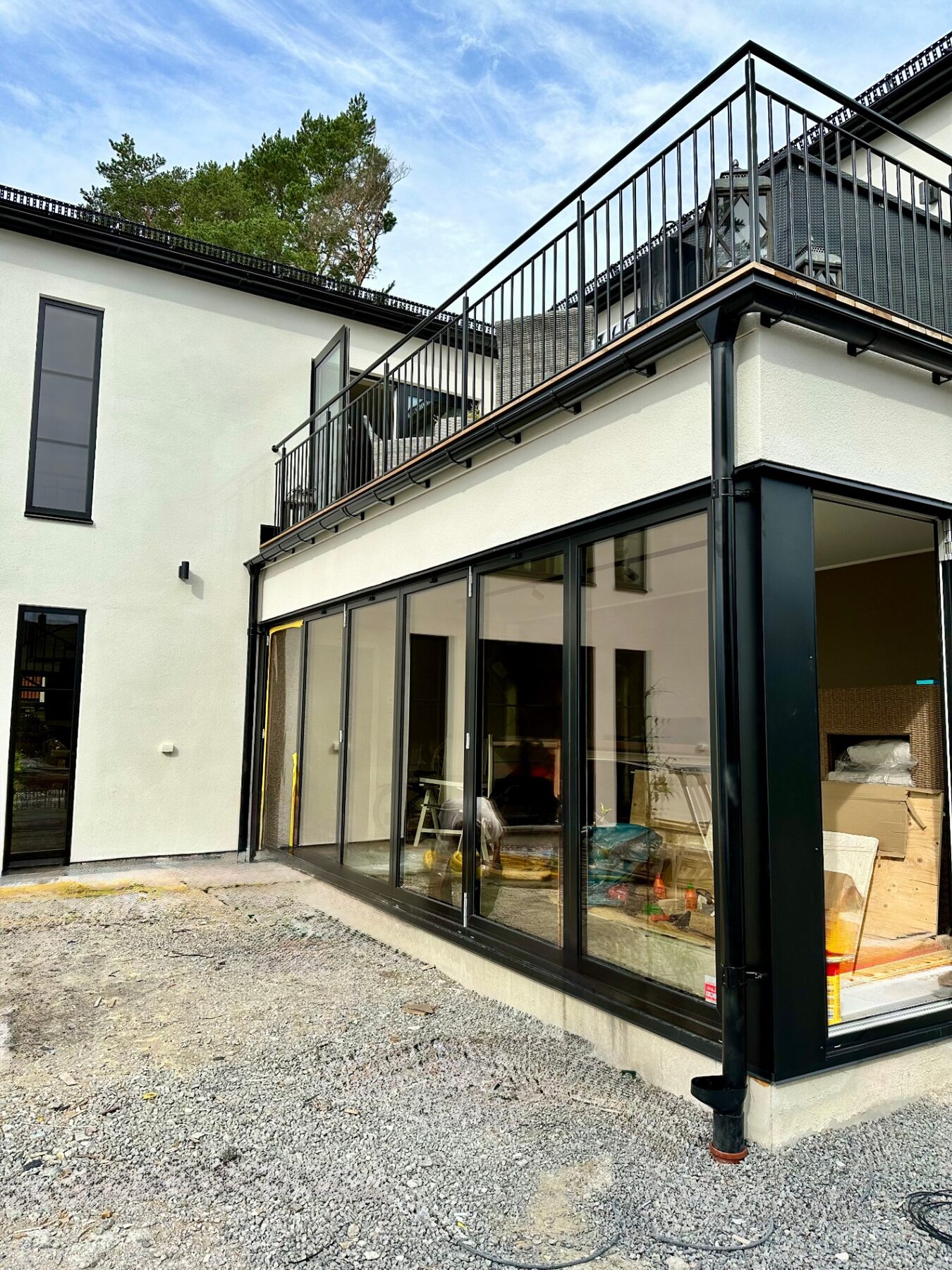 Corner balcony above the villa's full-height sliding glass doors