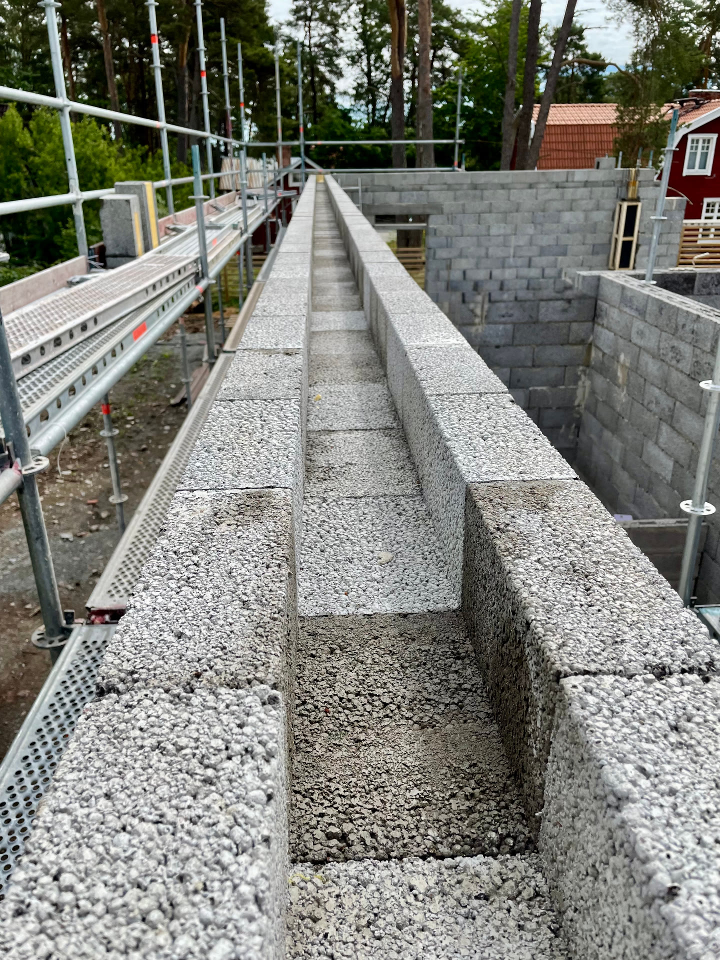 Ring beam channel formed along the top course of an insulated block wall